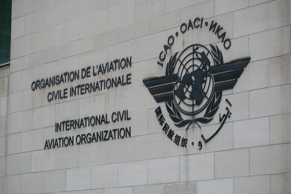 The International Civil Aviation Organization logo and name on a stone building wall