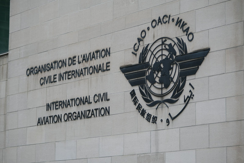 The International Civil Aviation Organization logo and name on a stone building wall